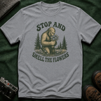Bigfoot Stop and Smell the Flowers T-Shirt — Sasquatch Holding Daisies Retro Nature Tee