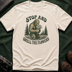 Bigfoot Stop and Smell the Flowers T-Shirt — Sasquatch Holding Daisies Retro Nature Tee